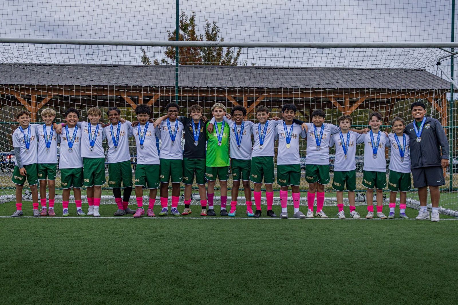 Triangle United travel team celebrating together after a tournament
