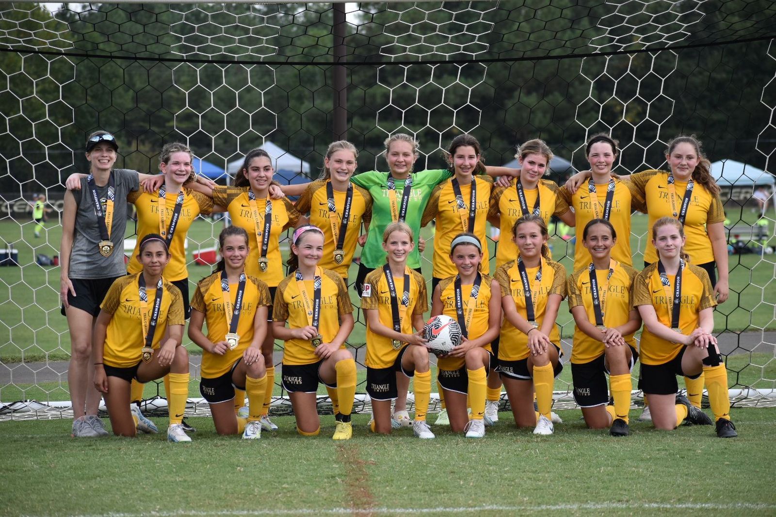 Girls Academy players celebrating together after a match